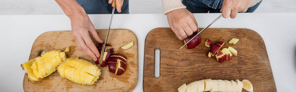 Top view of women cutting fresh fruits in kitchen, banner 