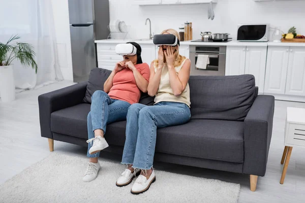 stock image Scared women in vr headsets playing video game on couch at home 