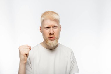 bearded albino man in t-shirt with clenched fist on white background clipart