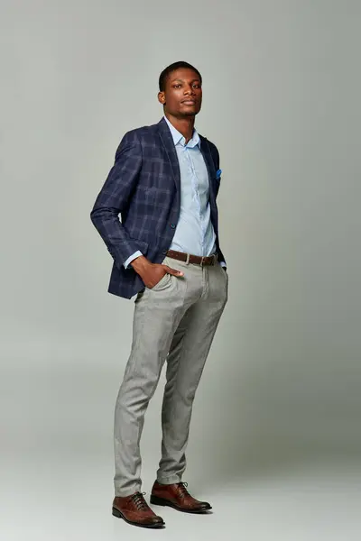 Handsome man in formal attire, sporting a blue jacket and grey pants. — Stock Photo