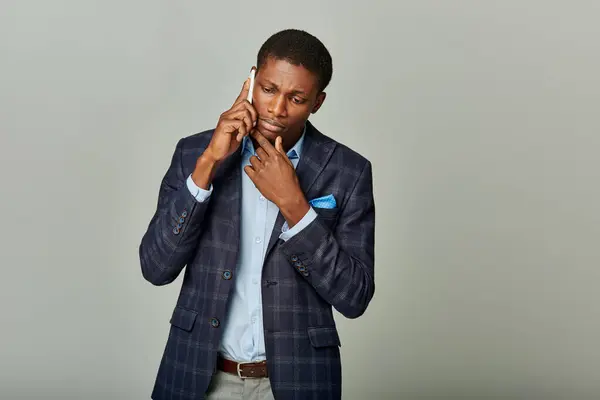 Handsome African American man in suit having phone call — Stock Photo