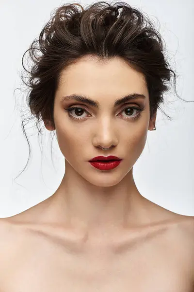 A portrait of a young woman in elegant attire, looking directly at the camera. — Stock Photo