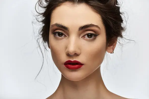 A close-up portrait of a woman with red lipstick and bold eyeliner. — Stock Photo