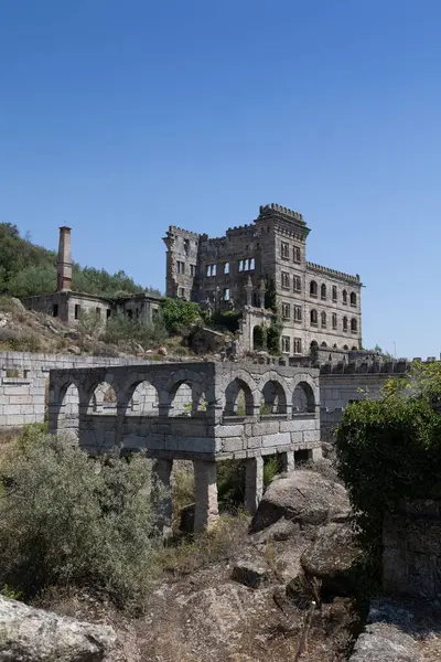 stock image Abandoned Termas Rdium (Hotel Serra da Pena) ruins in Sortelha, Portugal. This historic stone structure, nestled in a rugged landscape, symbolizes architectural decay and forgotten heritage