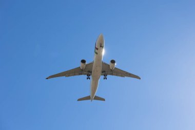 Lisboa, Portugal 2025-10-04 TAP Air Portugal airplane flying over Lisbon against clear blue sky, photographed from below. Editorial use only.