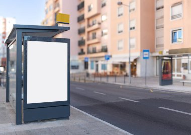 Blank billboard at a bus stop on a city street in Lisbona, ideal for advertisement mockup or outdoor marketing design.