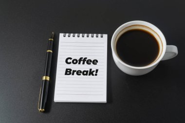 Siyah arka planda kahve molası veren bir kahve.