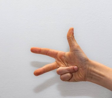 single hand showing three fingers against a white background, symbolizing counting, options, or the number three in various contexts clipart