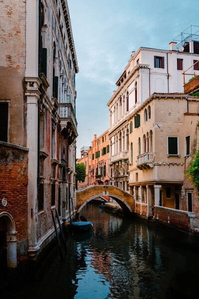 Venice, Italy - October 2022: Glimpse with characteristic bridge in the historic center of the lagoon city of Venice