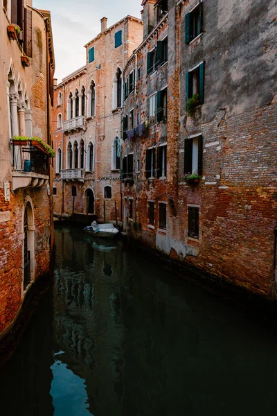 stock image Venice, Italy - October 2022: Venetian foreshortening with typical canal and boat moored under houses