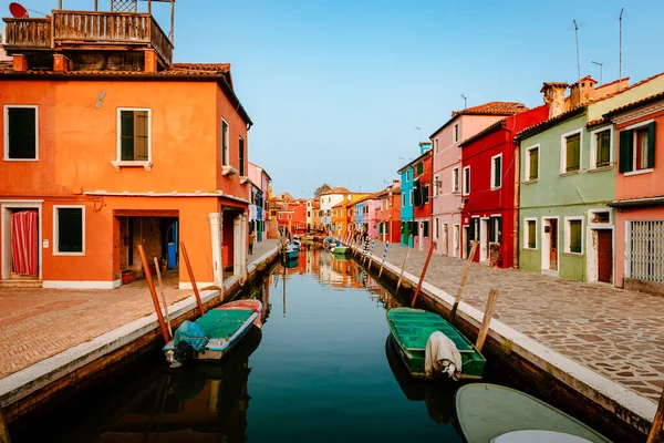 stock image Burano, Italy - October 2022: Picturesque Buranon street with canal and colorful houses at sunset