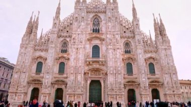 Duomo di Milanos 'un göz kamaştırıcı dış görünüşü açık bir kış günü turistleri Milans Duomo' nun görkemli ön cephesinde bir kış günü yürüyor..