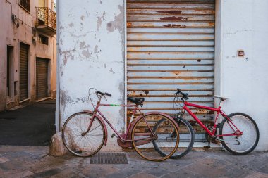 Nardo tarihi merkezindeki eski bir kepenkli dükkanın önüne park edilmiş klasik bisikletler.