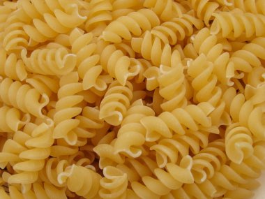 Çiğ İtalyan makarna arka planı. Makarnanın arka planı yakın plan. Ham gıda arkaplanı veya dokusu kapat.