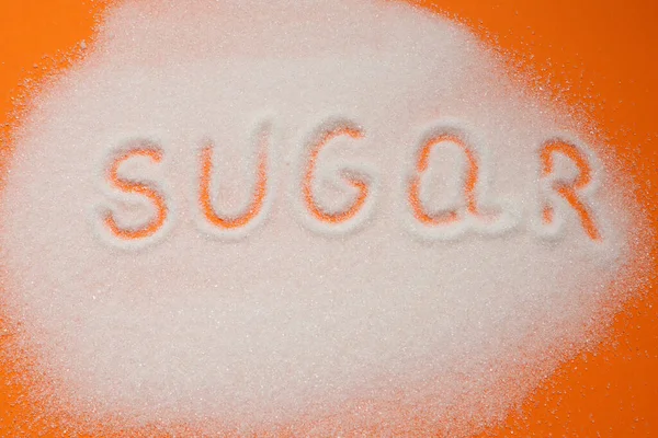 Inskriptionen Socker Socker Sand Orange Bakgrund Ordet Socker Hög Med — Stockfoto