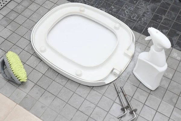 cleaning toilet seat restroom at house. disinfect, sanitize, hygiene care. Cleaning Toilets