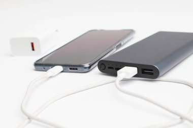 güç bankası ve beyaz arkaplanda akıllı telefon.