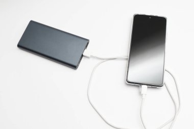 güç bankası ve beyaz arkaplanda akıllı telefon.
