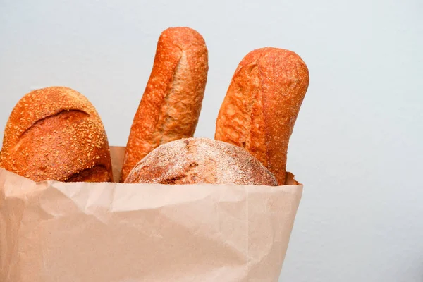 Baguette bread. Variety of bread in paper bag on white background.