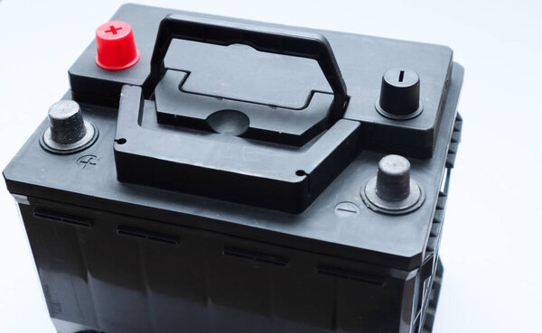 Black lead acid battery for car. Auto concept, isolated on white. Concept of service, maintenance, charging car battery
