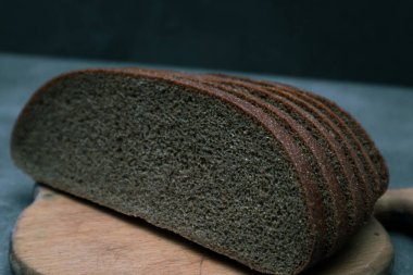 Sliced rye bread. Cross section of sliced rye bread on dark gray rustic background