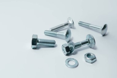Close-up of various steel nuts and bolts. Mechanical, constructional still life
