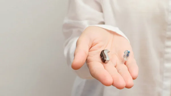 stock image Hearing aids. Close-up Of Doctor Showing Hearing Aid To Patient. Doctor showing hearing aid