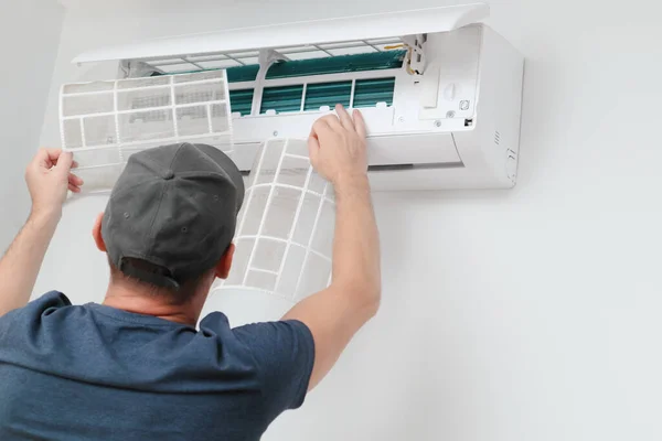 Air Conditioner Service Indoors Male Technician Removing Air Filter Air Royalty Free Stock Photos