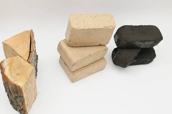 Wooden briquettes and firewood vs Peat briquettes on white background. Alternative fuel, eco fuel, bio fuel.