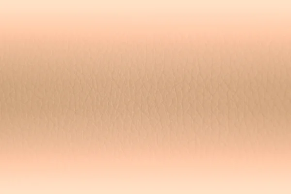 Close up of peach fuzz leather gradient background. Light peach leather texture. Light gradient backdrop, trendy peach fuzz color.