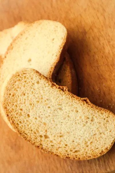 Bread crumbs on a wooden board, closeup view. Healthy vegan bread choice . Minimalism. Food.