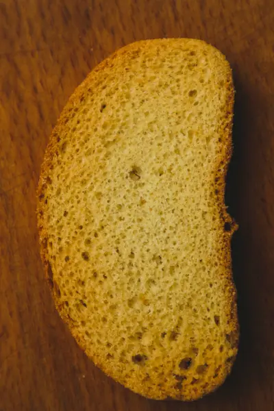 Bread crumbs on a wooden board, closeup view. Healthy vegan bread choice . Minimalism. Food.