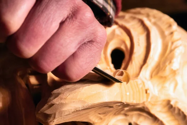 stock image Man is carving a wooden mask. Mann schnitzt eine Holzmaske