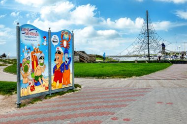 Bensersiel, Almanya, 19.09.2023: Komik motifli billboard ve Bensersiel Limanı 'na hoş geldiniz