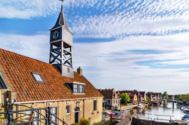 Hindeloopen, Netherlands. Lock with the wooden drawbridge and the lock keeper's house clipart