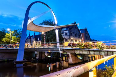 The architecturally beautiful Poortbrug/ bascule bridge was built over a canal in Leeuwarden and is the gateway to the city center clipart