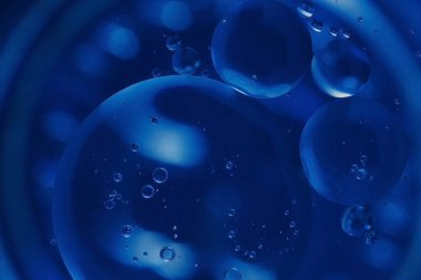 vegetable oil drops in water , abstract background