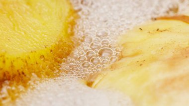 in a pot of boiling water , very tasty freshly picked mushrooms are cooked , a close - up view from above , edible gifts of the forest