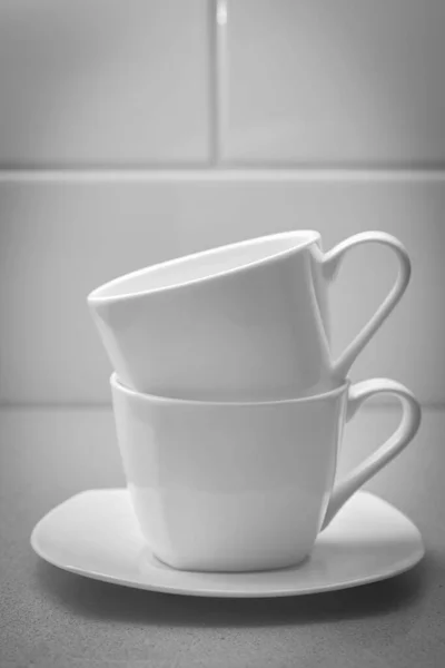 Two White Coffee Mugs Standing One Top Other White Saucer — Stock Photo, Image