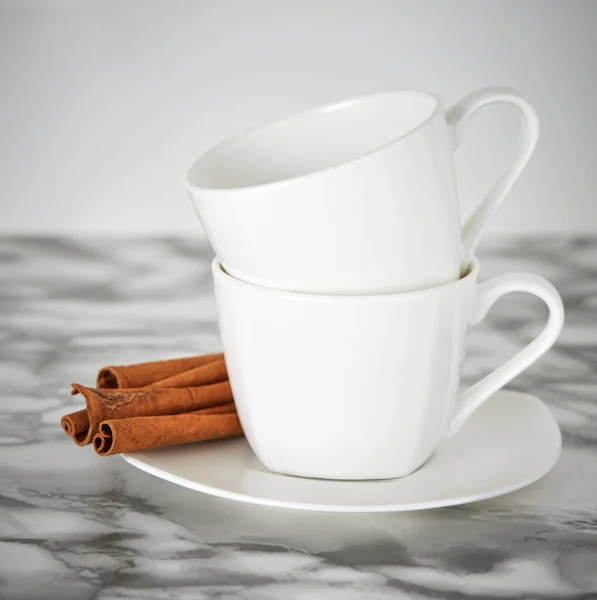 Two White Coffee Mugs Standing One Top Other White Saucer — Stock Photo, Image