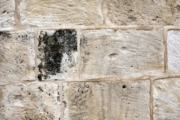the texture of the old stone Jerusalem wall in beige color, natural stone, the photo can be used as a background
