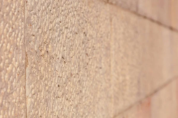 the texture of the old stone Jerusalem wall in beige color, natural stone, the photo can be used as a background