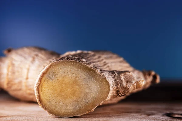 a dry ginger root is photographed in close-up on a beautiful background , a macro photo of the plant