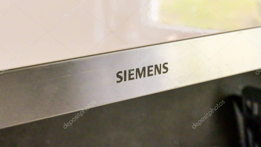 Europe, Germany - 10 APRIL 2025: Siemens sign at a microwave in a kitchen. High quality photo
