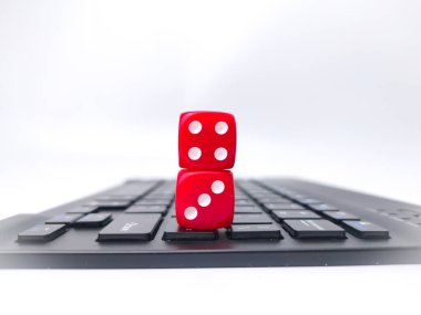 Red dice on keyboard.Playing dice for game online on computer keyboard