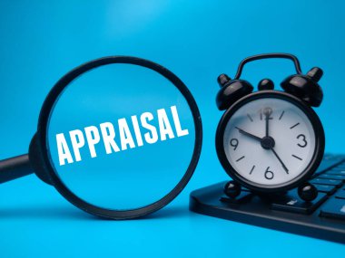 Magnifying glass and alarm clock with the word APPRAISAL.