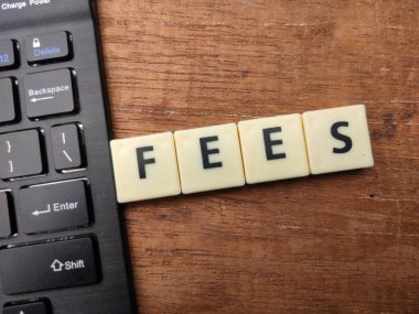 Keyboard and toys word with the word FEES