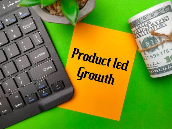 Keyboard and banknotes with the word Product Led Growth on green background.