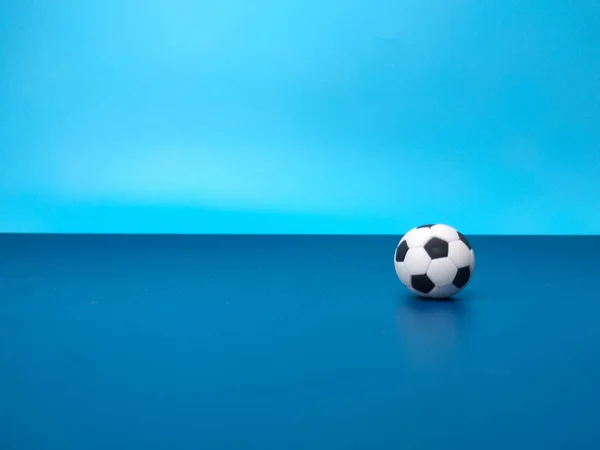 A ball is on a blue background with copy space for text.
