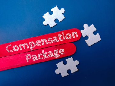Puzzle and ice cream stick with word Compensation Package on blue background. Business concept.